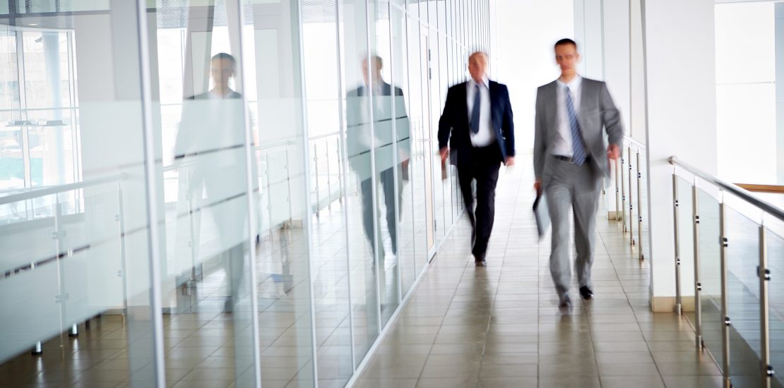 People in office Business people walking in the office corridor